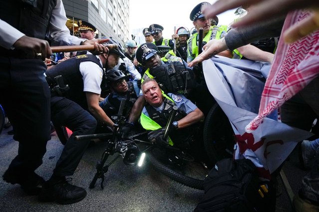 Demonstrators clash with police near the Israeli Consulate during the Democratic National Convention Tuesday, August 20, 2024, in Chicago. (Photo by Julio Cortez/AP Photo)