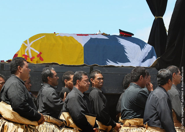 The Royal casket of King George Tupou V is carried towards the Royal Tombs during the State Funeral held for King George Tupou V at Mala'ekula