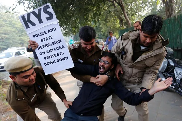 A demonstrator is detained by police outside the Assam bhawan (building) during a protest against a new citizenship law, in New Delhi, India, December 23, 2019. (Photo by Danish Siddiqui/Reuters)