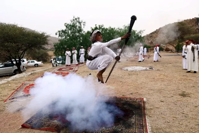 A man fires a weapon as he dances during a traditional excursion near the western Saudi city of Taif, August 8, 2015. (Photo by Mohamed Al Hwaity/Reuters)