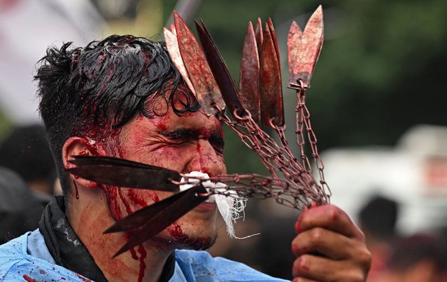 A Kashmiri Shiite Muslim mourner self-flagellates during a Muharram procession on the eighth day of Ashura in Srinagar on July 27, 2023, after the state government allowed the Muharram procession through its traditional route for the first time in three decades. (Photo by Tauseef Mustafa/AFP Photo)