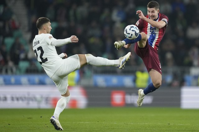 Slovenia's Adam Gnezda Cerin, left, and Norway's Lasse Johnsen go for the ball during the UEFA Nations League soccer match between Slovenia and Norway at Stozice stadium in Ljubljana, Slovenia, Thursday, November 14, 2024. (Photo by Darko Bandic/AP Photo)