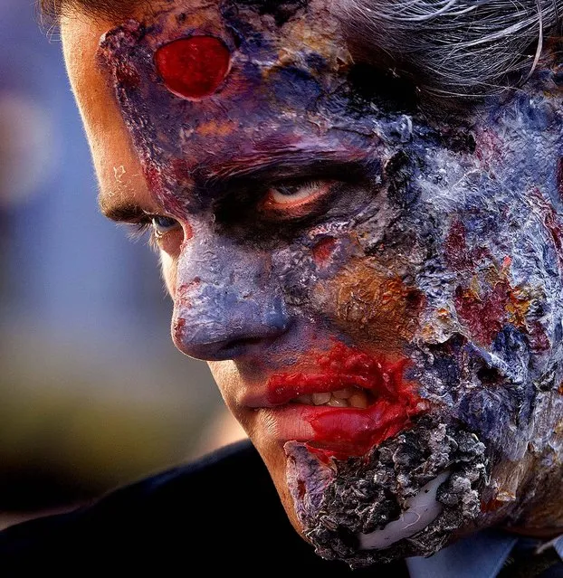 Batman fan Brian Haughs, 28, from Indiana, role plays as “Two-Face”, a fictional supervillain, while waiting for the opening of  The Dark Knight Rises,  the third in Christopher Nolan's Batman trilogy, at Universal CityWalk in Los Angeles on July 19, 2012. (Photo by Damian Dovarganes/Associated Press)