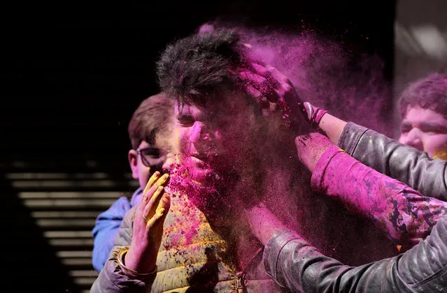 Indians smear colored powder on each other as they celebrate Holi in Jammu, India, Monday, March 9, 2020. Holi, the Hindu festival of colors, also heralds the coming of spring. (Photo by Channi Anand/AP Photo)