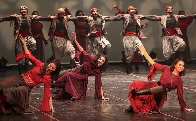 Members of the Funoun Palestinian Popular Dance Troupe perform during the Palestine International Festival for Music and Dance (PIF) in the city of Ramallah in the occupied West Bank on June 30, 2022. (Photo by Abbas Momani/AFP Photo)