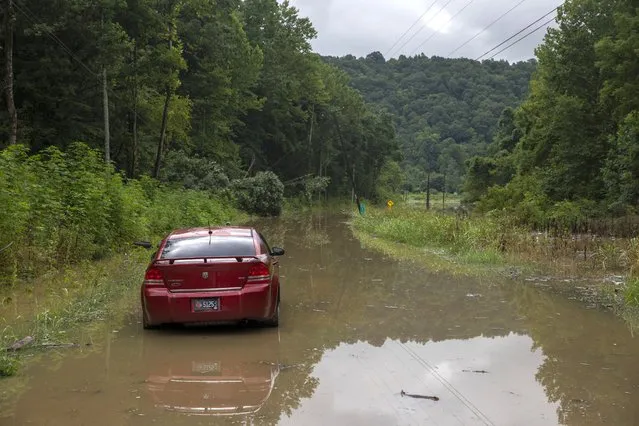 A car sits in floodwaters along KY-28. The water made the route impassable in Chavies, Kentucky on Friday, July 29, 2022. (Photo by Arden S. Barnes/The Washington Post)