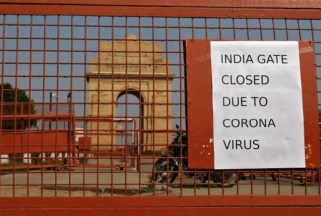 A sign pasted on a security barricade is seen after the India Gate war memorial was closed for visitors amid measures for coronavirus prevention in New Delhi, India, March 19, 2020. (Photo by Adnan Abidi/Reuters)