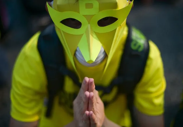 A protestor offers prayers on the second day of a demonstration demanding Prime Minister Najib Razak's resignation and electoral reforms in Kuala Lumpur on August 30, 2015. Tens of thousands of Malaysians swarmed central Kuala Lumpur on August 29, to call for the prime minister's ouster over corruption allegations and demand broader reforms, defying warnings by police who had declared the rally illegal. (Photo by Mohd Rasfan/AFP Photo)