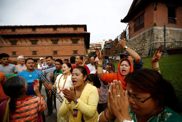 Devotees sing and dance at Pashupatinath temple to mark the Shrawan Sombar festival in Kathmandu, Nepal, July 18, 2016. (Photo by Navesh Chitrakar/Reuters)