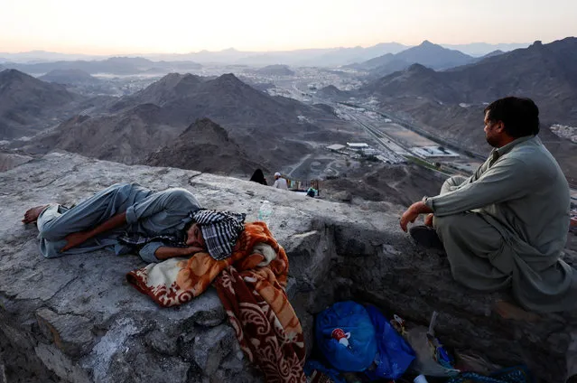 A Muslim pilgrim sleeps on the Mount of Al-Noor, where Muslims believe Prophet Mohammad received the first words of the Koran through Gabriel in the Hira cave, near the holy city of Mecca, Saudi Arabia on July 4, 2022. (Photo by Mohammed Salem/Reuters)
