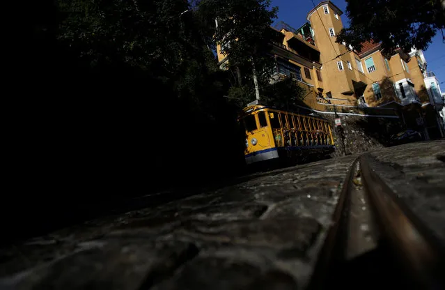 A bonde (tram) is seen in the Santa Teresa neighbourhood in Rio de Janeiro, Brazil, July 14, 2016. Rio de Janeiro is a marvel and a mess all at once. When it hosts the first ever Olympics in South America, starting Aug. 5, visitors will see a city whose stunning topography – stark, verdant mountains loom over packed and playful beaches – competes only with the drama of daily life here. Despite drug gangs, violent crime, gaping inequality an heavy pollution, the natural splendour of Rio makes even locals joke that no matter how hard they may try, they somehow never manage to ruin the place. (Photo by Ricardo Moraes/Reuters)