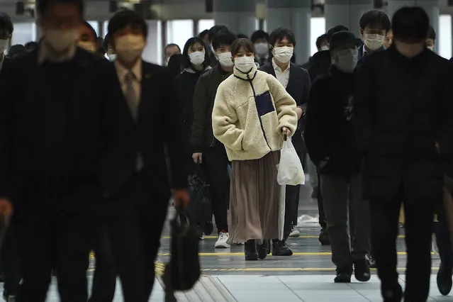 A station passageway is crowded with face mask wearing commuters during a rush hour Monday, April 20, 2020, in Tokyo. Japan's Prime Minister Shinzo Abe expanded a state of emergency to all of Japan from just Tokyo and other urban areas as the virus continues to spread. (Photo by Eugene Hoshiko/AP Photo)