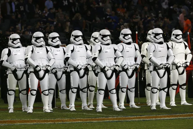 Stormtroopers line up on the field during halftime of an NFL football game between the Chicago Bears and the Minnesota Vikings, Monday, October 9, 2017, in Chicago. The trailer for “Star Wars: The Last Jedi” debuted in dramatic fashion during Monday Night Football halftime. Fireworks flashed and Stormtroopers marched onto Chicago's Soldier Field as the preview played onscreen. (Photo by Charles Rex Arbogast/AP Photo)