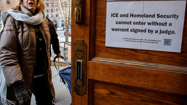 A sign prohibiting ICE and Homeland Security from entering without a warrant is posted on a door at St. Paul and St. Andrew United Methodist Church while a woman enters the church in New York City, U.S., January 23, 2025. (Photo by Eduardo Munoz/Reuters)