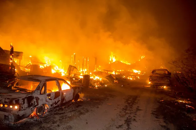 Vehicles and structures burn off of Highway 138 as the Blue Cut Fire rages through San Bernardino County Tuesday August 16, 2016. The fire has scorched at least 18,000 acres and forced 82,000 people to evacuate their homes in San Bernardino County. (Photo by Kevin Warn via ZUMA Wire)
