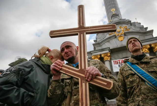 Comrades react during the funeral ceremony for ultra-nationalist Ukrainian volunteers “Aydar Battalion” servicemen Sergey Kochetov and Nikolay Sayuk, who were reportedly killed in the conflict in eastern Ukraine, at the Independence Square in Kiev, Ukraine, 04 November 2016. Pro-Russian separatists attacked Ukrainian army positions in eastern Ukraine 31 times in the past 24 hours, including 17 attacks in the Mariupol sector, and seven in the Luhansk and the Donetsk sectors each, according to the Ukrainian government's official press center for the so-called Anti-Terrorist Operation (ATO). (Photo by Roman Pilipey/EPA)