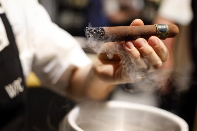 Chef Garry Larduinat holds up a chocolate “cigar” at the 97th Oscars Governors Ball Preview held at the Ray Dolby Ballroom in Los Angeles, California, USA, 25 February 2025. (Photo by Caroline Brehman/EPA/EFE)