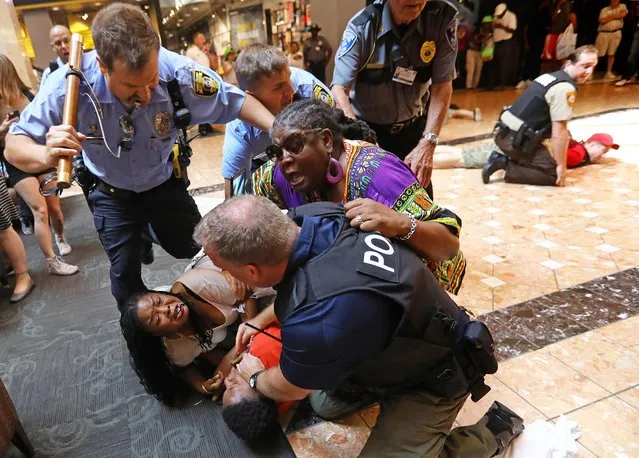 In a Saturday, September 23, 2017 photo, police make several arrests of people protesting the Sept. 15 acquittal of former police officer Jason Stockley in the death of a black man, at the St. Louis Galleria. (Photo by Christian Gooden/St. Louis Post-Dispatch via AP Photo)