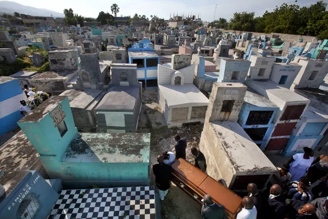 In this Oct. 9, 2014 photo, relatives carry a coffin through the National Cemetery in Port-au-Prince, Haiti. Cemetery overcrowding is an issue that resonates around the world, particularly in its most cramped cities and among religions that forbid or discourage cremation. (AP Photo/Dieu Nalio Chery)