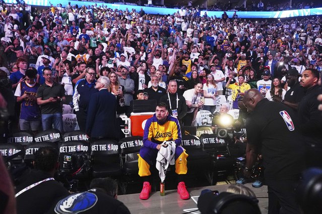 Los Angeles Lakers' Luka Doncic sits on the bench looking up at a video that was played in the arena as a tribute to the former Mavericks player before an NBA basketball game against the Dallas Mavericks in Dallas, Wednesday, April 9, 2025. (Photo by LM Otero/AP Photo)