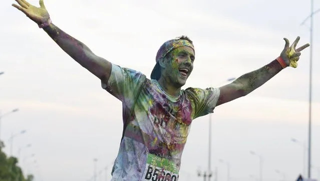 A participant is covered by colored powder as he competes in The Color Run, a five-kilometre untimed race, in Hanoi, Vietnam September 26, 2015. (Photo by Reuters/Kham)