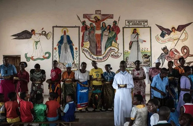 People gather for Sunday service at Mofolo Woyera church in the village of Mulele, which lies in one of the areas most affected by drought, on September 11, 2016 in Zomba, Malawi. The drought has hurt the community's harvest leaving many in need of food aid. Drought associated with the El Nino weather pattern has created famine throughout Southern Africa with over 60 million people dependent on food aid. (Photo by Andrew Renneisen/Getty Images)