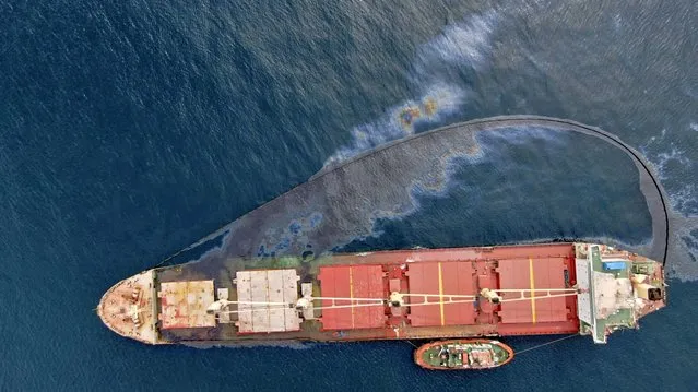 In this photo provided by the Gibraltar government and taken on Thursday September 1, 2022, a leak of heavy fuel oil, a small amount of which has escaped the perimeter of the boom sits on the surface of the sea by the Tuvalu-registered OS 35 cargo ship that collided with a liquid natural gas carrier in the bay of Gibraltar on Tuesday.  Gibraltar authorities say they have beached a cargo ship to prevent it from sinking after it collided with a liquefied natural gas carrier in the Bay of Gibraltar. A government spokesman said that the situation was under control and the cargo ship was not in danger. He said there has been no environmental impact so far. (Photo by HM Government of Gibraltar via AP Photo)
