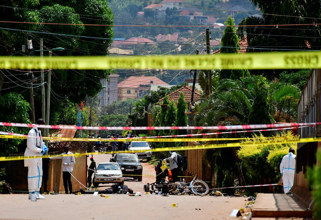 Forensic experts secure the scene of a bomb blast near the Munyonyo Martyrs' Shrine, a Roman Catholic shrine as Ugandans assembled to celebrate Martyrs' Day, which commemorates Christians who were killed for their faith in the 19th century, in Munyonyo suburb of Kampala, Uganda on June 3, 2025. (Photo by Abubaker Lubowa/Reuters)