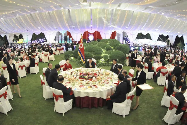 This photo provided by the North Korean government shows North Korean leader Kim Jong Un, center, and his wife Ri Sol Ju, center left, attend a celebration marking the nation's anniversary, at the parliament in Pyongyang, North Korea, September 8, 2022. (Photo by Korean Central News Agency/Korea News Service via AP Photo)