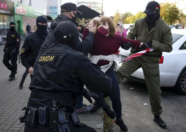 Police officers detain a woman during an opposition rally to protest the official presidential election results in Minsk, Belarus, Saturday, September 19, 2020. (Photo by TUT.by via AP Photo)