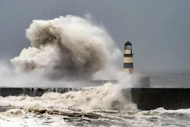 Waves crash against the lighthouse in Seaham Harbour, County Durham on Thursday, November 17, 2022. Motorists are being warned to stay off the roads as cars have become stuck in flood water caused by downpours and the UK prepares to suffer “miserable conditions” over the next two days. (Photo by Danny Lawson/PA Images via Getty Images)