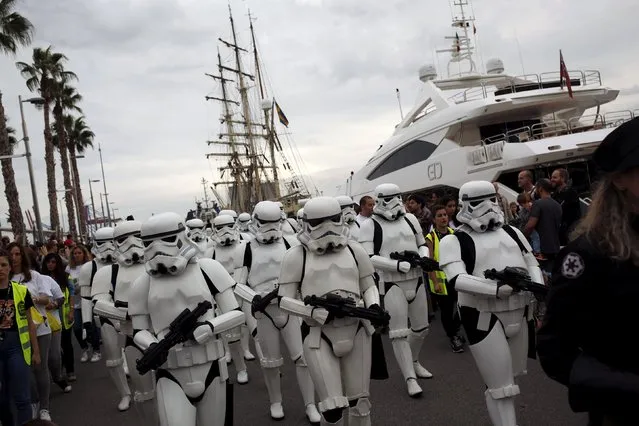 Members of the 501st Legion Spanish Garrison dress up as "Stormtroopers" from the "Star Wars" movies during a solidarity parade to spread the message of bone marrow donation and the fight against cancer, organized by the Luis Olivares Foundation in downtown Malaga, southern Spain, October 24, 2015. (Photo by Jon Nazca/Reuters)