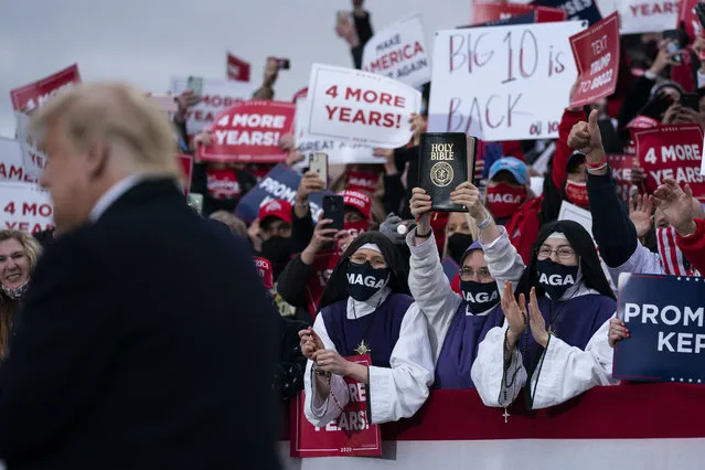 Supporters of President Donald Trump cheer as he arrives for a campaign rally at Pickaway Agricultural and Event Center, Saturday, October 24, 2020, in Circleville, Ohio. (Photo by Evan Vucci/AP Photo)