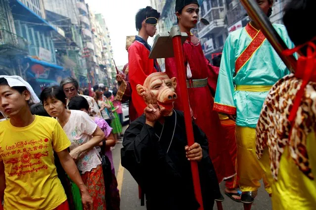 A festival attendee, dressed as Zhu Bajie, a character from the Chinese novel "Journey to the West", poses during a festival dedicated to Buddhist monk Shin Upagutta, celebrated by Myanmar's ethnic Chinese community in Chinatown, in Yangon October 21, 2015. (Photo by Soe Zeya Tun/Reuters)