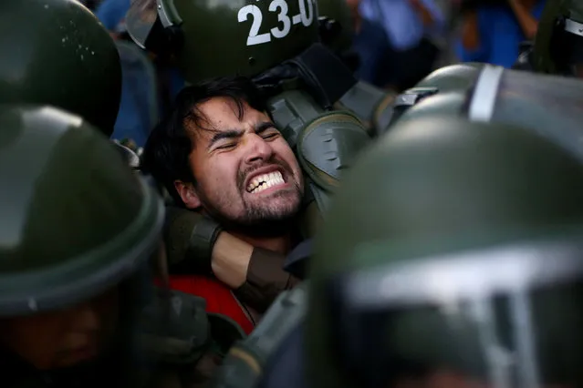A demonstrator is detained during a protest demanding an end to profiteering in the education system in Santiago, Chile, March 27, 2018. (Photo by Ivan Alvarado/Reuters)