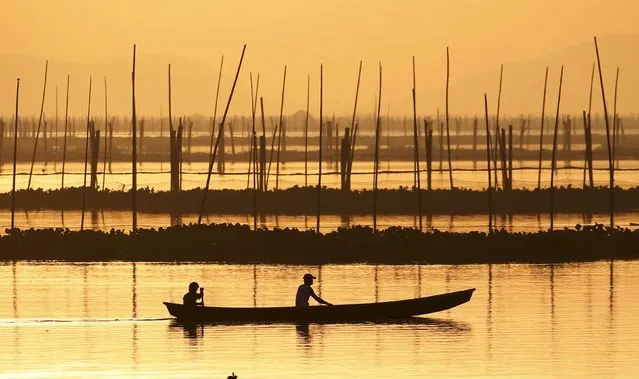 A fisherman rides on a banca to inspect fish pens that needs to be dismantled to make way for an expressway at Laguna de Bay in Muntinlupa, Metro Manila October 7, 2015. (Photo by Erik De Castro/Reuters)