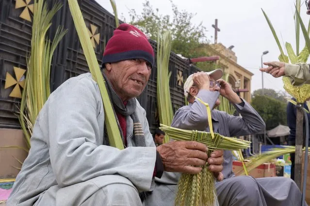 Vendors sell palm leaves during the Palm Sunday mass at the Church and Monastery of the Virgin Mary, in Cairo, Egypt, Sunday, April 9, 2023. Christians in Egypt are celebrating Palm Sunday, the start of the Holy Week that leads up to Easter. (Photo by Amr Nabil/AP Photo)