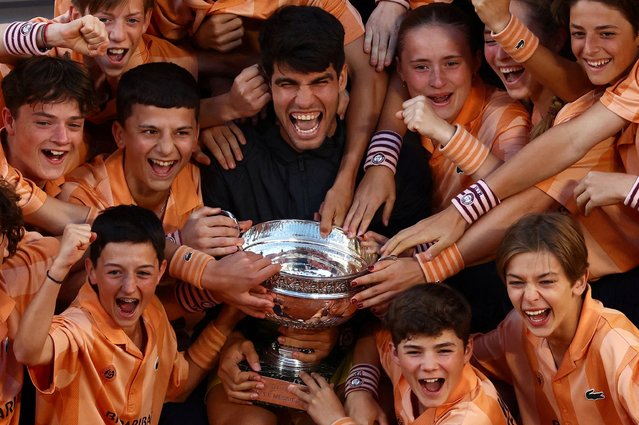 Winner Carlos Alcaraz of Spain poses with the ball kids after beating Alexander Zverev of Germany in the men's final on Day 15 of the 2024 French Open at Roland-Garros Stadium on June 9, 2024 in Paris, France. (Photo by Lisi Niesner/Reuters)