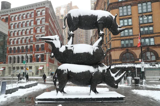 “The Last Three” rhino sculpture is covered in snowfall in Astor Place, New York City on March 21, 2018. The incredible 17-foot-tall interactive artwork is being created to raise critical awareness about rhino conservation. (Photo by Gordon Donovan)