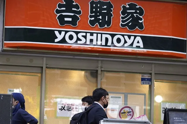 A signboard of a Yoshinoya restaurant, a fast food beef bowl chain, is seen Wednesday, April 5, 2023, in Tokyo. Japanese police have arrested two men on suspicion of shoveling ginger condiment into his mouth directly from a communal container with his chopsticks at a famous beef bowl restaurant in western Japan, a latest in the series of food pranks that had earlier hit sushi chains and known as “sushi terrorism”. (Photo by Eugene Hoshiko/AP Photo)