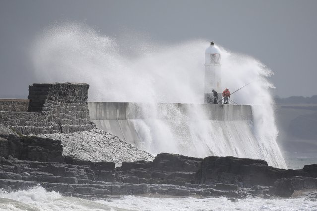 Fishermen brave stormy seas as large waves crash over them at Porthcawl in Wales, UK on August 31, 2025. Britain is seeing unsettled weather as the remnants of Tropical Storm Fernand and Hurricane Erin bring wind and rain. (Photo by Joann Randles/Cover Images)