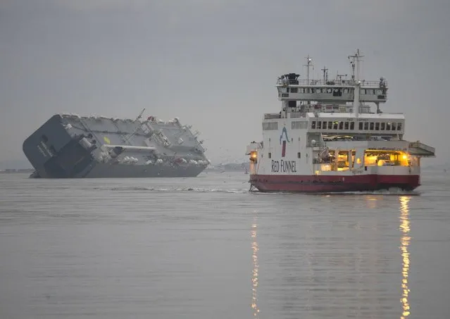 The cargo ship Hoegh Osaka lies on its side after being deliberately ran aground on the Bramble Bank in the Solent estuary, near Southampton in southern England January 5, 2015. (Photo by Peter Nicholls/Reuters)