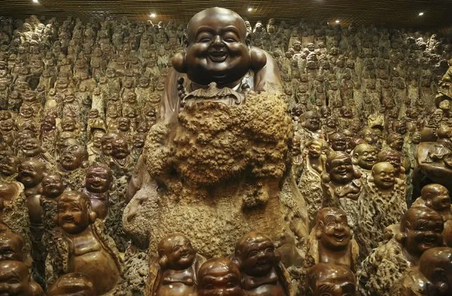 Buddha sculptures made of trunks of Chinese date trees are seen inside a room of a company selling dates, in Zhengzhou, Henan province, China, November 23, 2015. The room contains over 9,200 different buddha scluptures made of discarded Chinese date tree trunks, local media reported. (Photo by Reuters/Stringer)