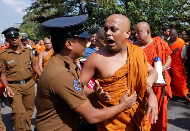 Sri Lankan Buddhist monks protest against the complete implementation of the 13th constitutional amendment as a solution to long-standing ethnic issues, near the parliament main entrance road, Colombo, Sri Lanka on February 8, 2023. (Photo by Dinuka Liyanawatte/Reuters)