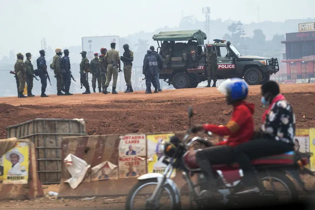 Security forces gather in Kampala, Uganda, Thursday, January 14, 2021. Ugandans are voting in a presidential election tainted by widespread violence that some fear could escalate as security forces try to stop supporters of leading opposition challenger BobiWine from monitoring polling stations. (Photo by Jerome Delay/AP Photo)