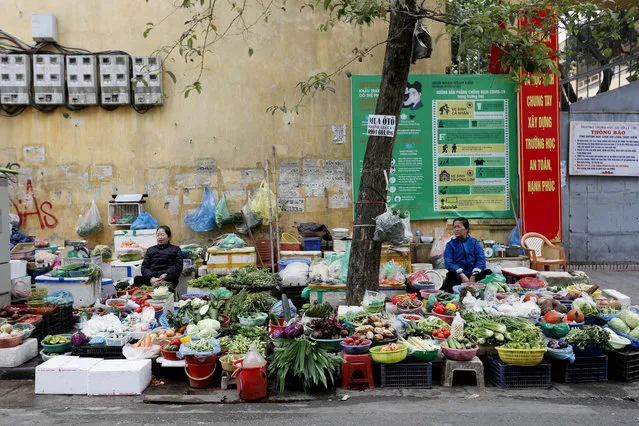 Women sell vegetables at a street market in Hanoi, Vietnam, 05 January 2021. Vietnam's gross domestic product (GDP) growth is forecast to reach 6.8 percent in 2021, according to a report released by the World Bank. (Photo by Luong Thai Linh/EPA/EFE)