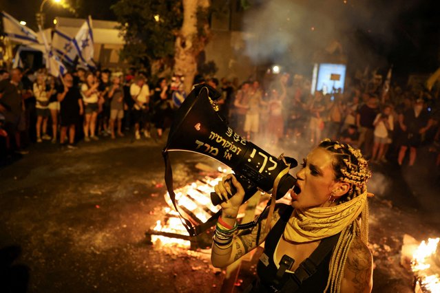 A protester uses a megaphone during a protest against the government and to show support for the hostages who were kidnapped during the deadly October 7 attack, in Tel Aviv on September 2, 2024. (Photo by Florion Goga/Reuters)