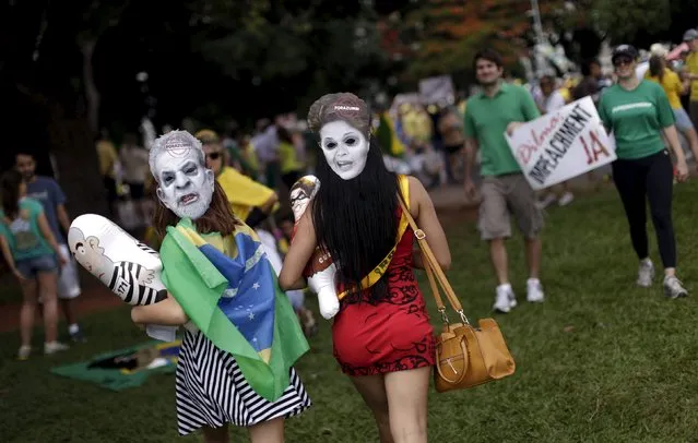 Demonstrators wear masks depicting Brazil's former president Luiz Inacio Lula da Silva (L) and Brazil's President Dilma Rousseff during a protest calling for the impeachment of Rousseff near the National Congress in Brasilia, Brazil, December 13, 2015. (Photo by Ueslei Marcelino/Reuters)