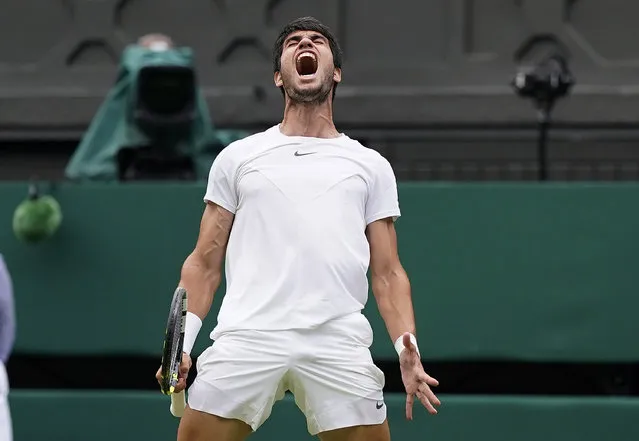 Spain's Carlos Alcaraz celebrates as he wins a point against Italy's Matteo Berrettini in a men's singles match on day eight of the Wimbledon tennis championships in London, Monday, July 10, 2023. (Photo by Alberto Pezzali/AP Photo)