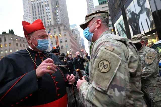 Cardinal Timothy Dolan, Archbishop of New York, greets a member of the 69th Infantry Division, nicknamed the fighting 69th, before the start of a St. Patrick's Day Mass at St. Patrick's Cathedral in Manhattan on March 17, 2021 in New York City. Cardinal Timothy Dolan, Archbishop of New York, held Mass in honor of Saint Patrick, the Patron Saint of the archdiocese. The traditional St. Patrick's Day festivities in NYC were cancelled due to the coronavirus (COVID-19) pandemic. (Photo by Michael M. Santiago/Getty Images)